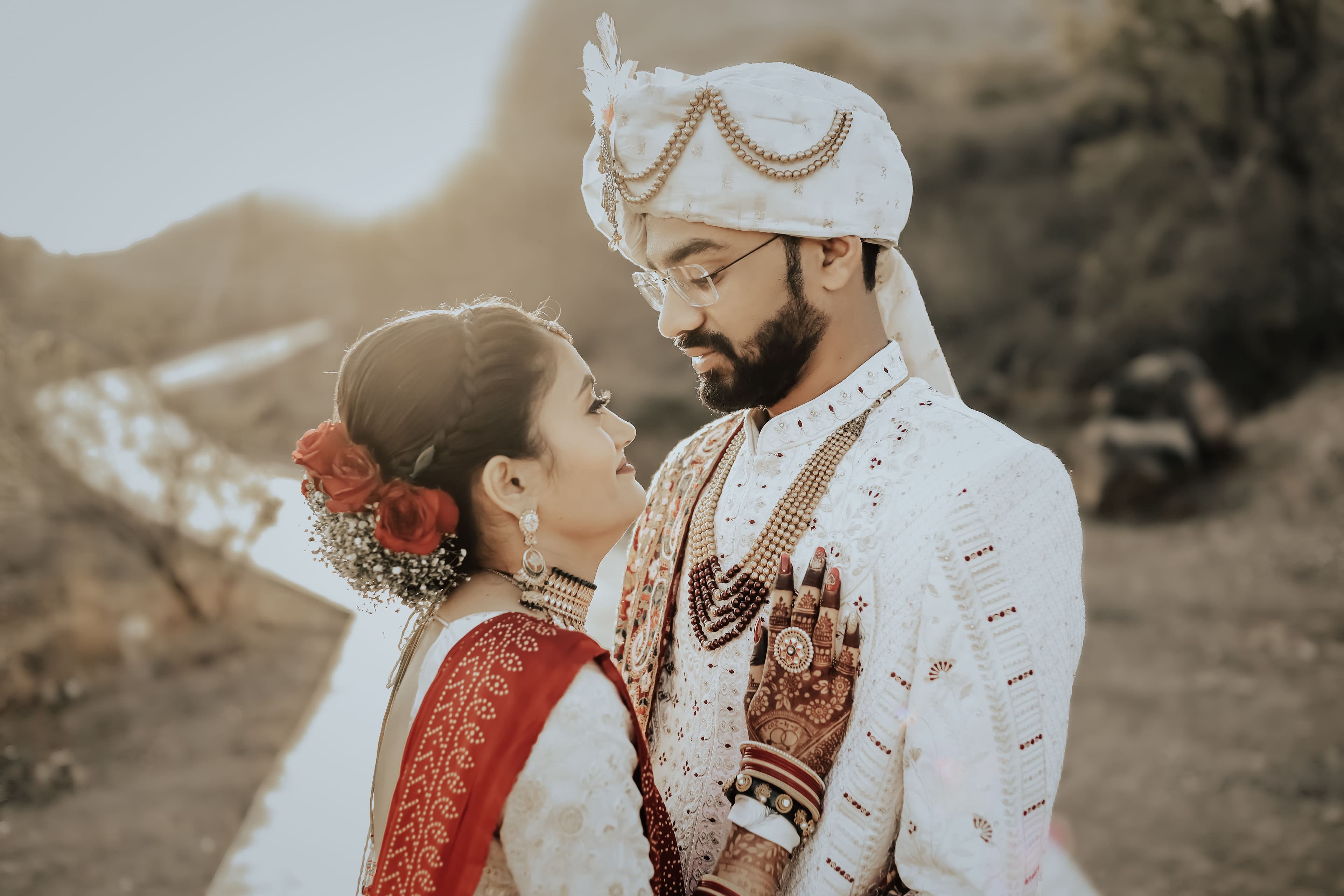 Indian bride and groom in traditional wedding attire, looking at each other