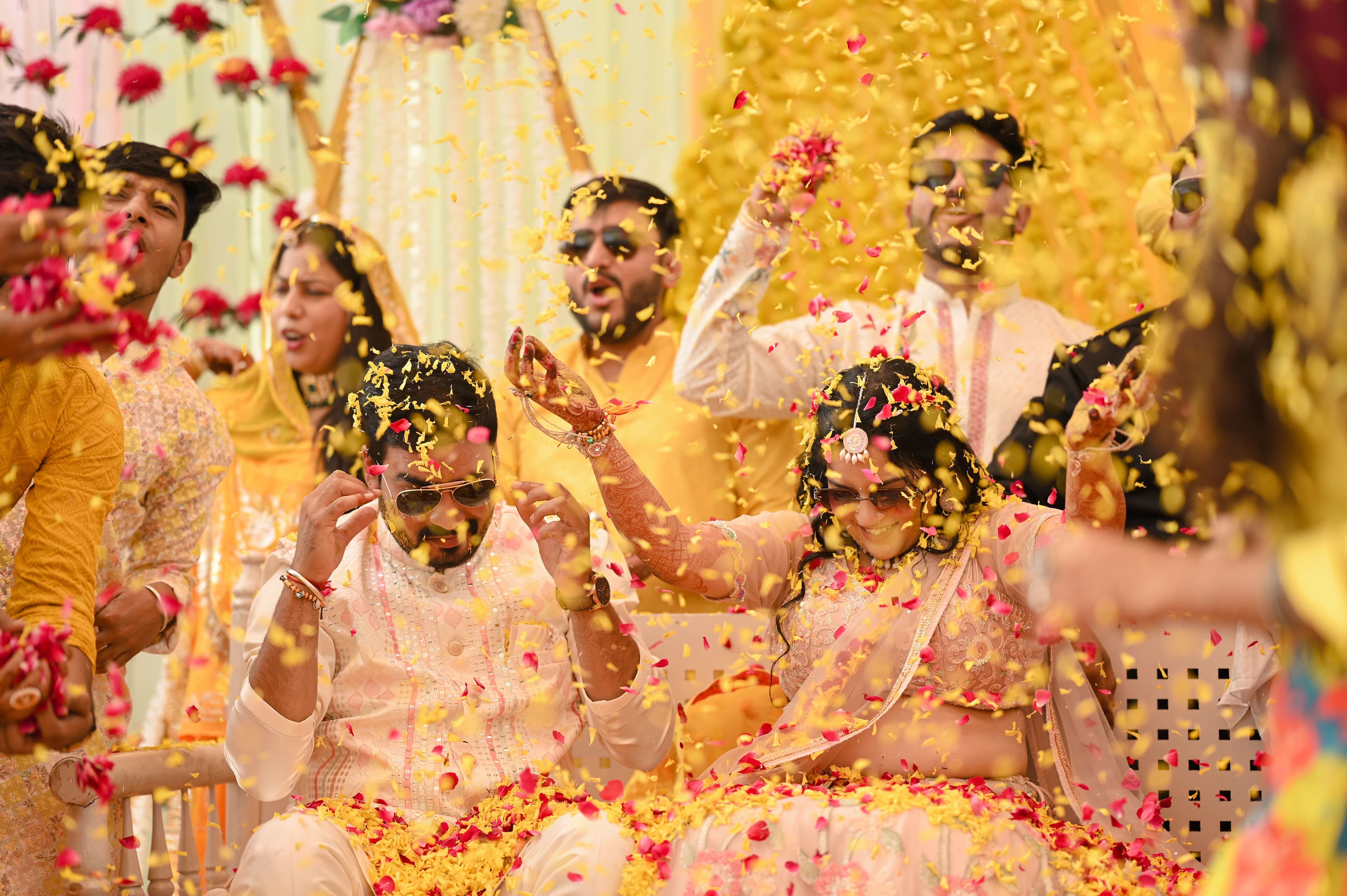 Bride and groom celebrating amid a shower of flower petals