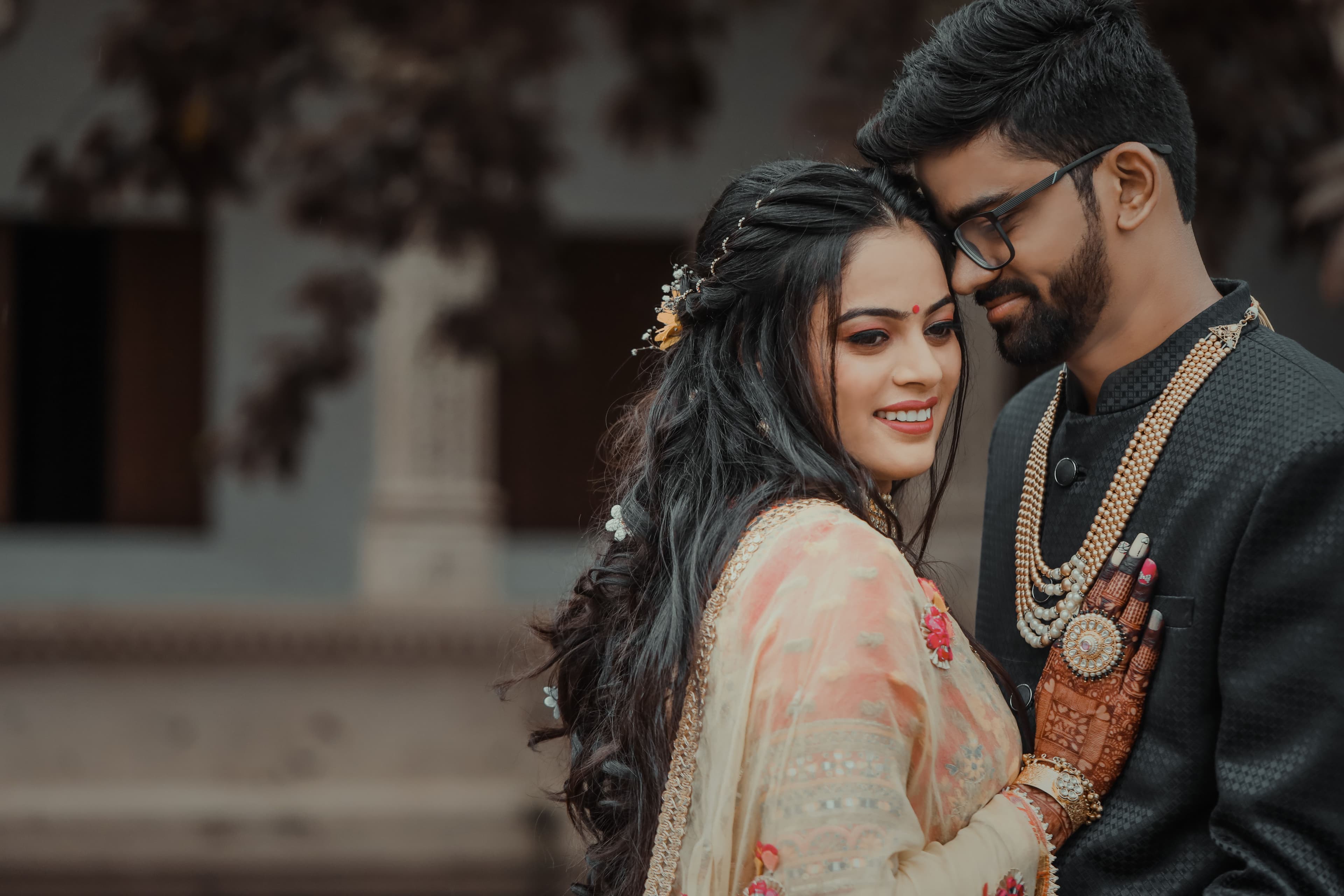 Bride and groom in an intimate embrace, foreheads touching